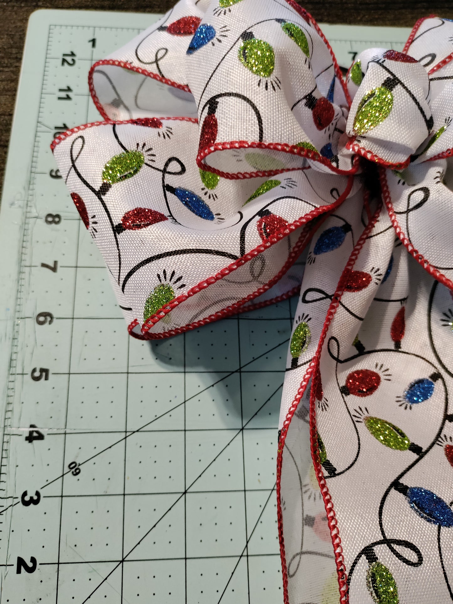 White Bow with Green, Red, and Blue Light Bulbs